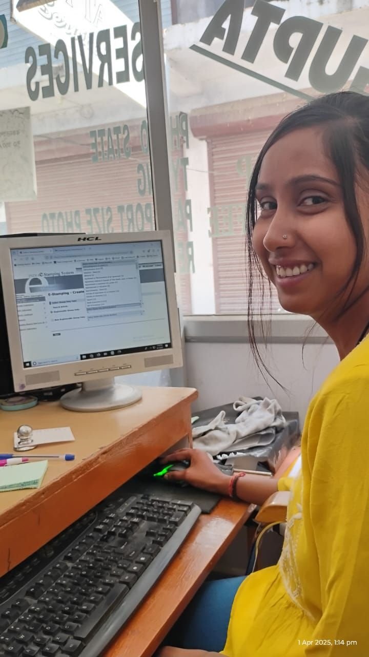 A young woman operating an e-stamping terminal at a common service centre