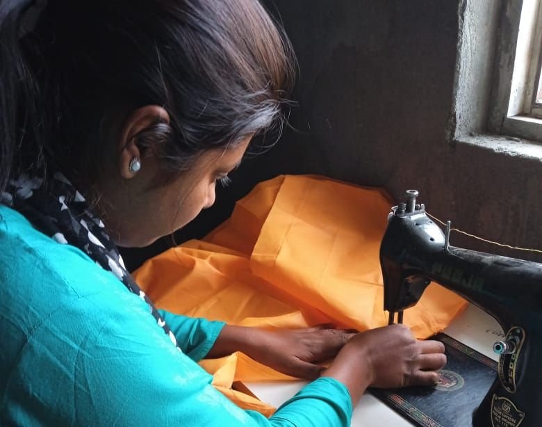 A trainee at her sewing machine during a tailoring batch, Rasoolpur
