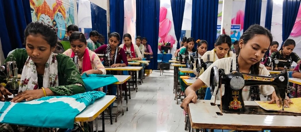 Trainees at sewing machines during a tailoring practical session in Sitarganj
