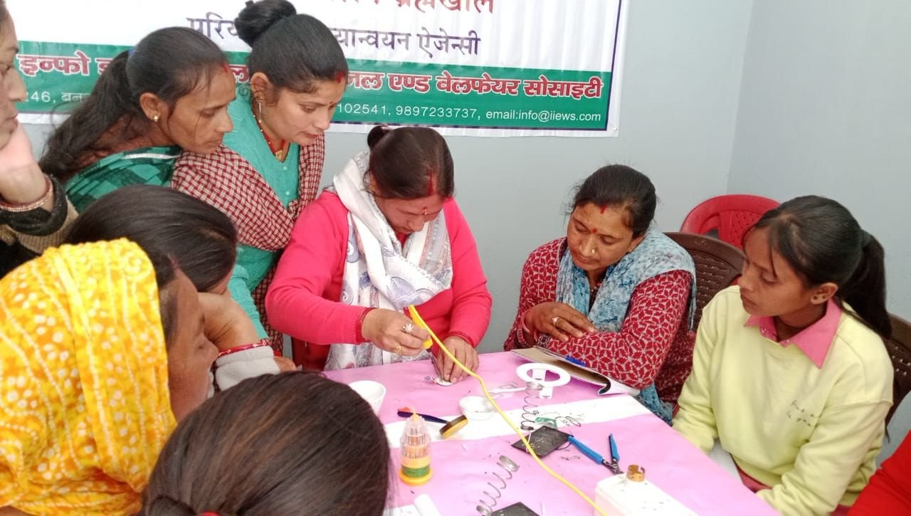 Women assembling LED bulbs during an enterprise training session