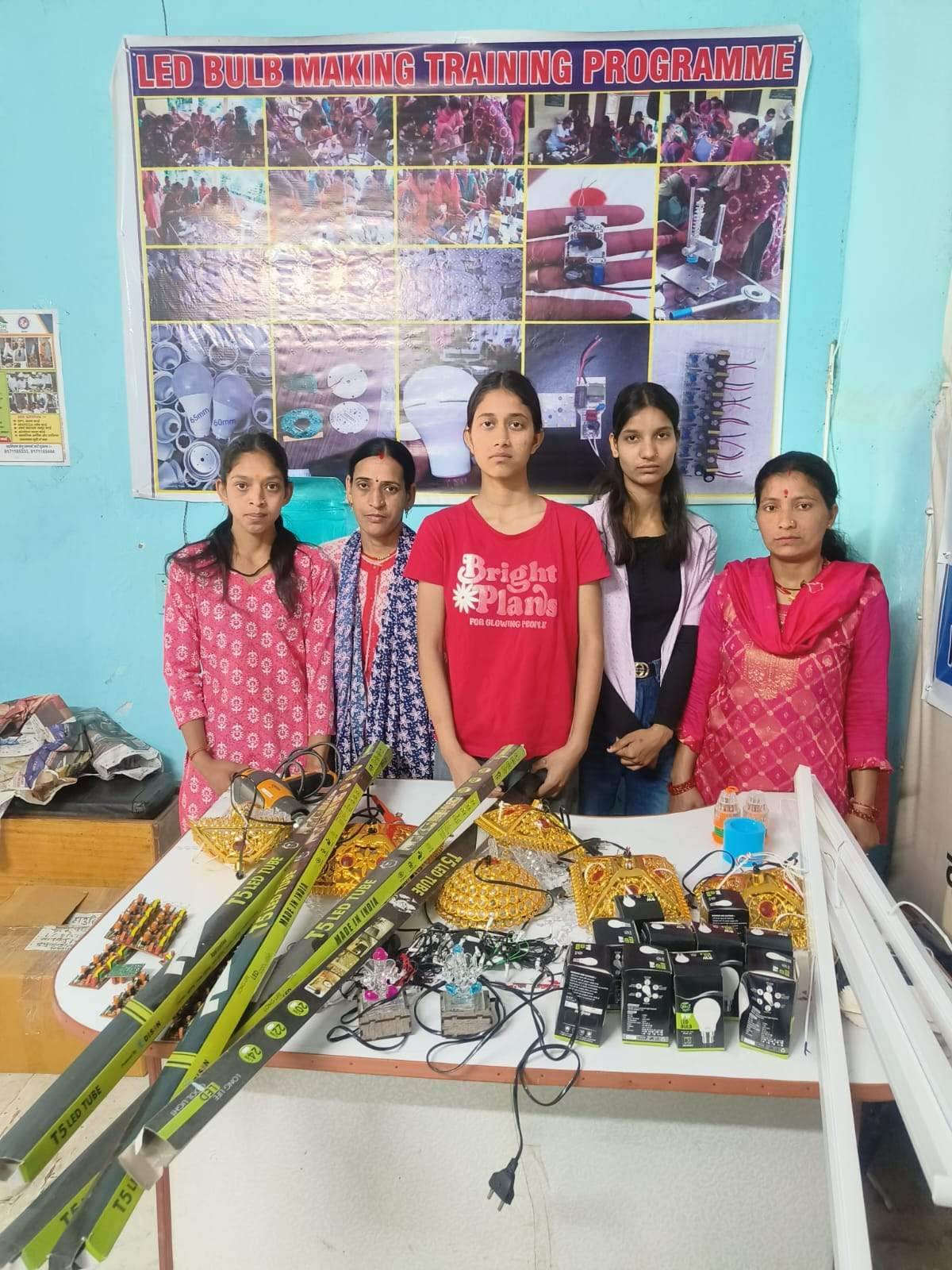 Self-help group members with their produce and craft display at a district exhibition